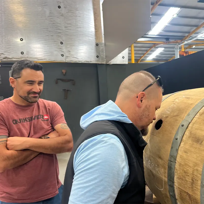 Man peering into barrel