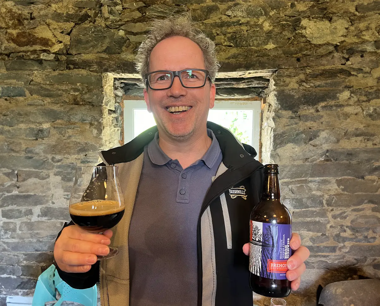 Excited man with beer bottle and beer glass