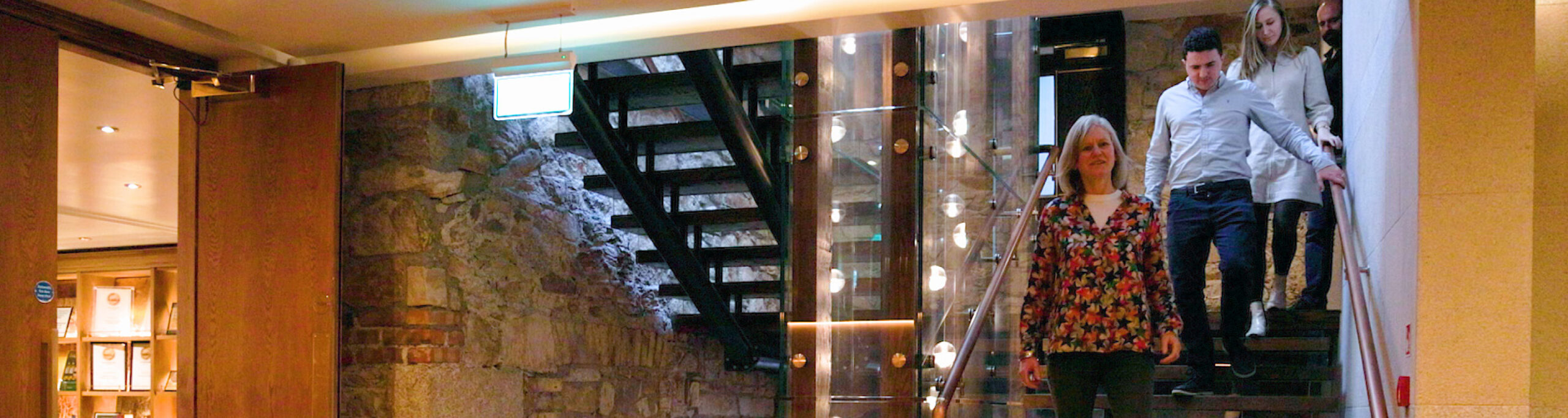 Group coming down fancy staircase