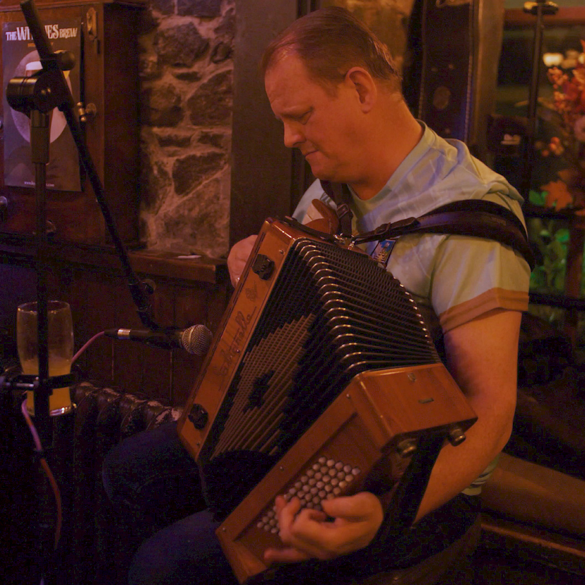 Man playing accordian in pub
