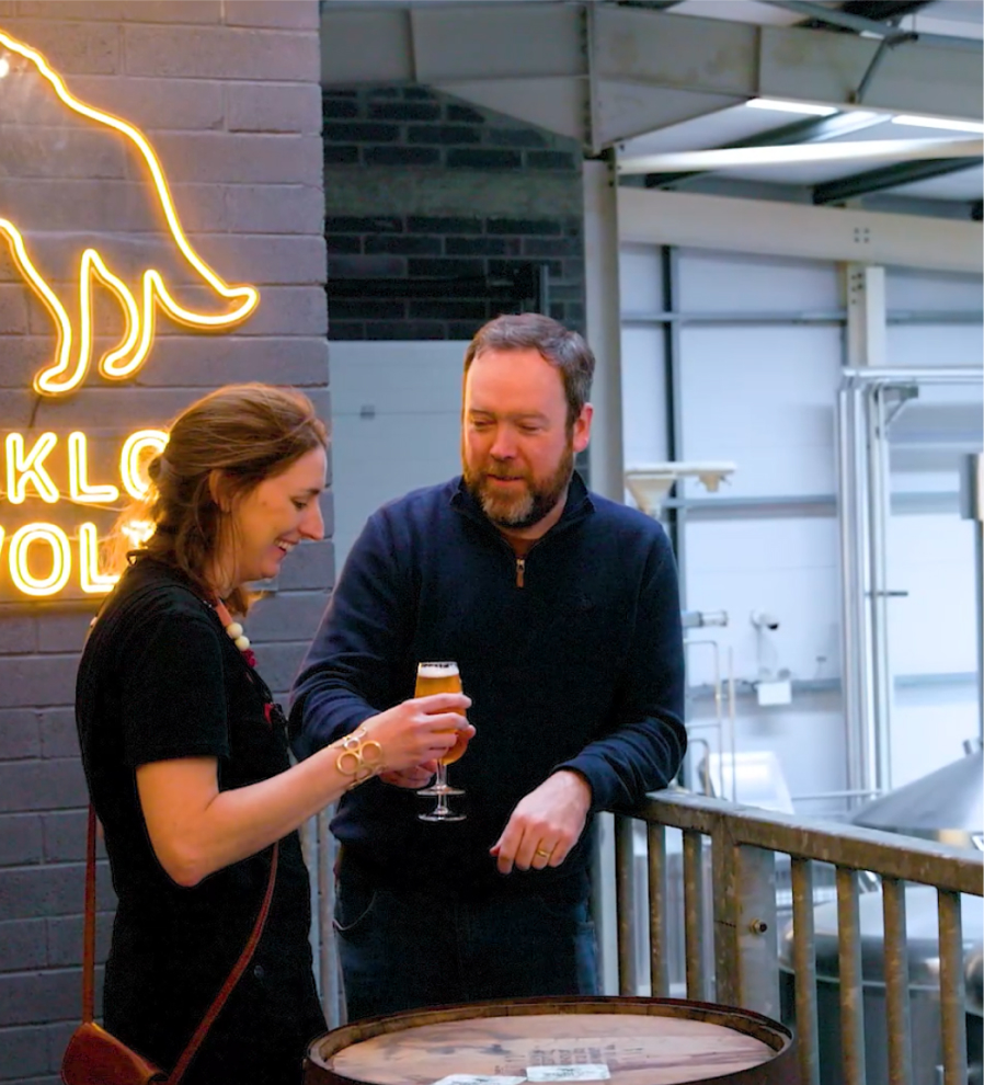 Two people cheers-ing their glasses