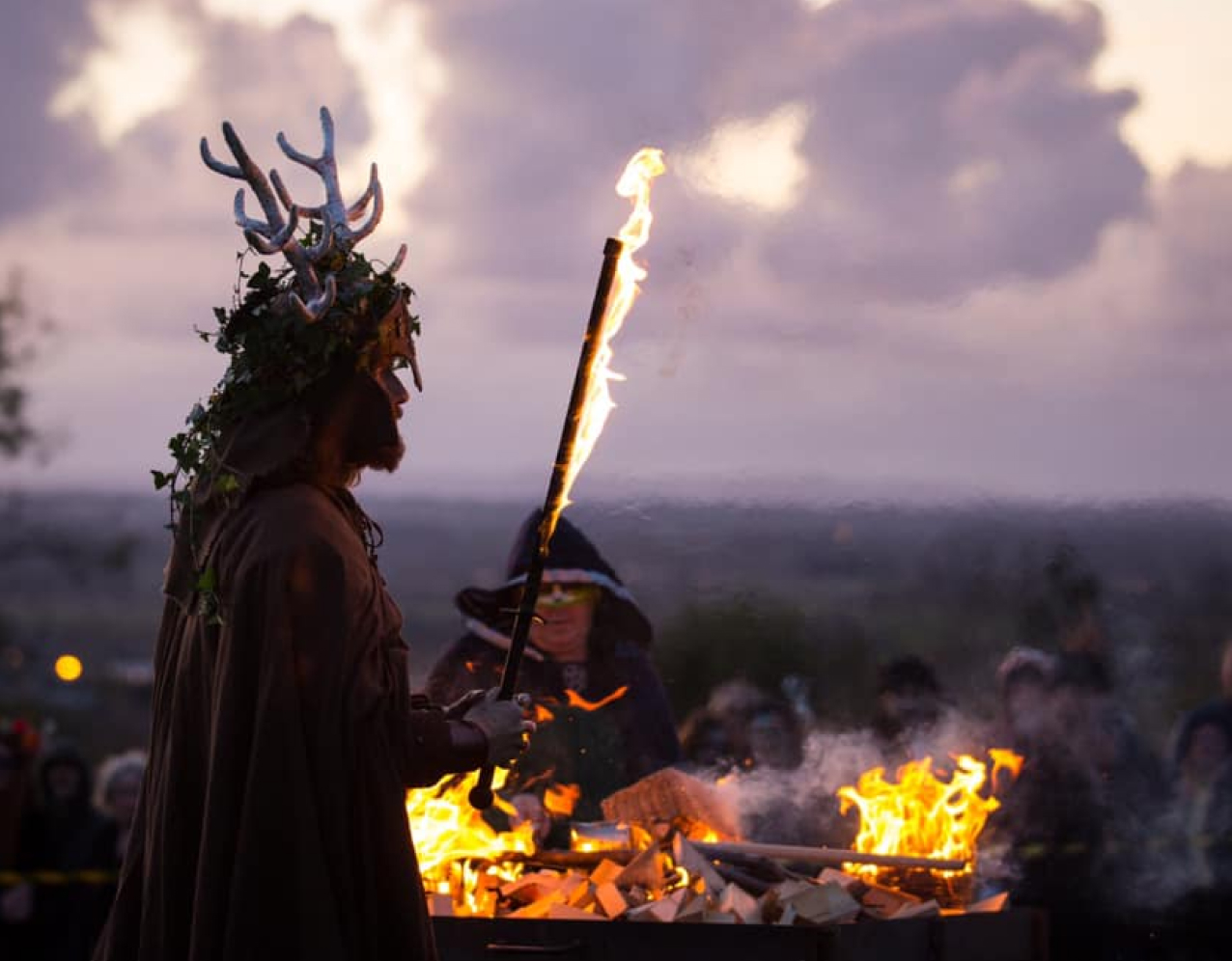 Halloween festival, man dressed up with flaming rod