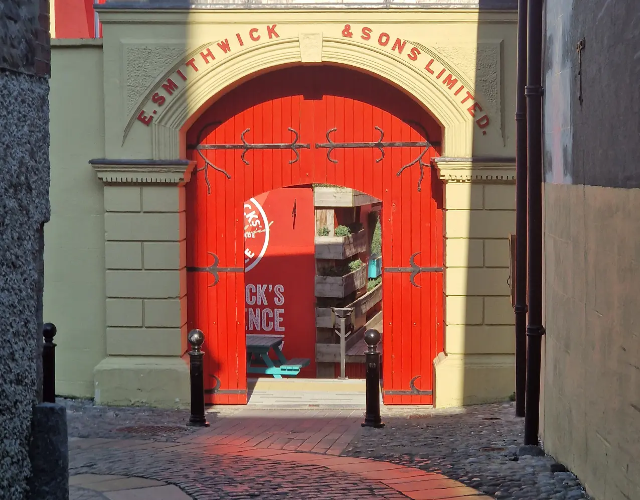Smithwick's entrance, a big red arched door inside a yellow wall