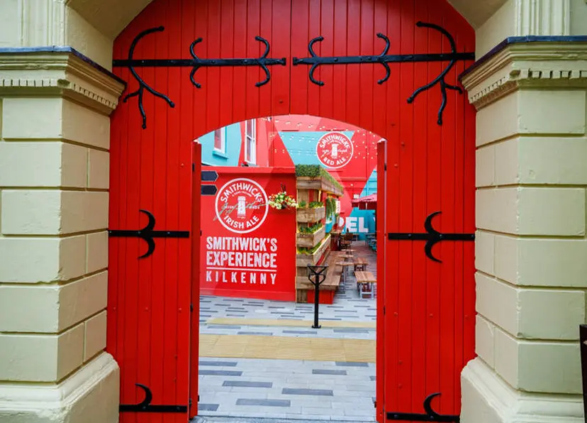 Smithwicks Entrance red door in yellow wall