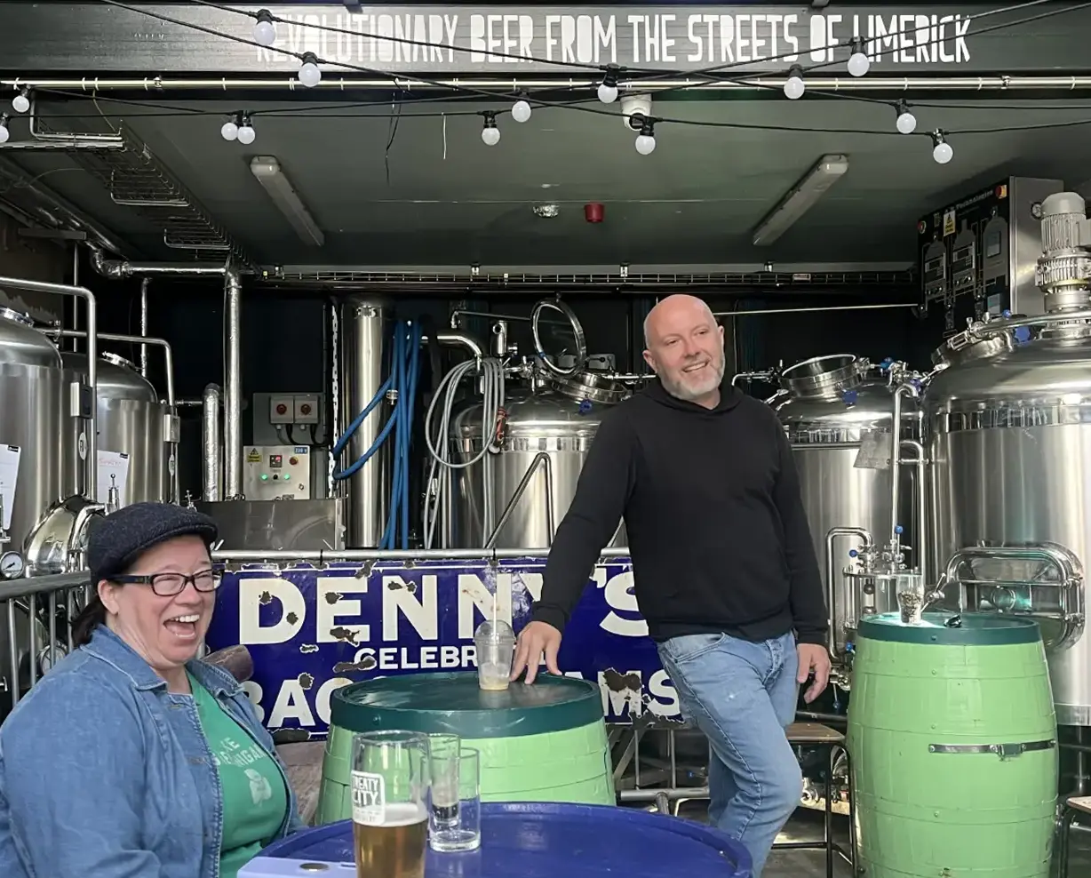 Laughing in Treaty City in front of brewing equipment