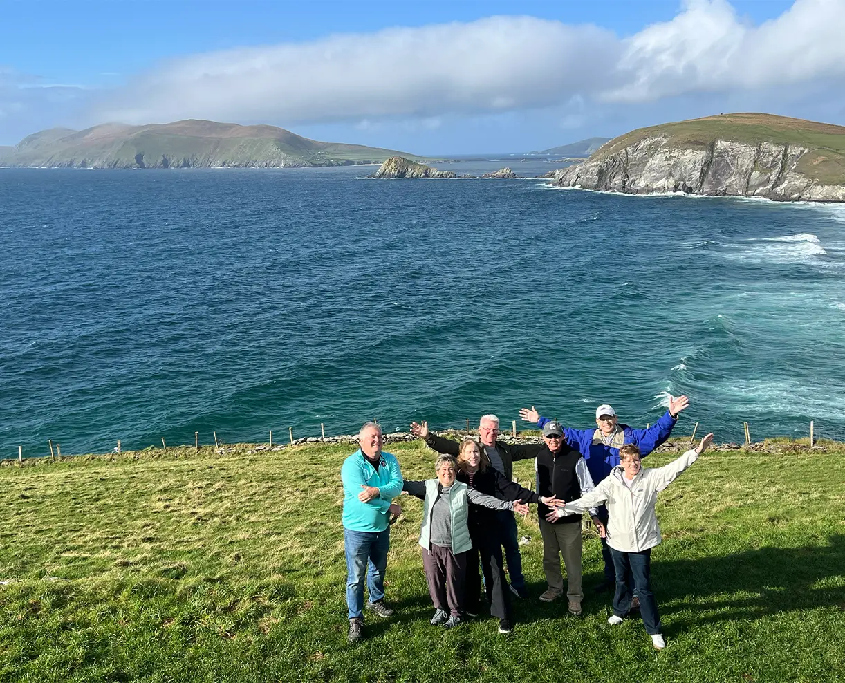 Tour group standing in front of cliff